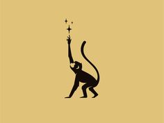 a monkey holding a sparkler in the air with its arm up to it's head