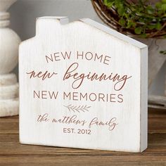 a wooden sign that says new home, new beginning and new memories