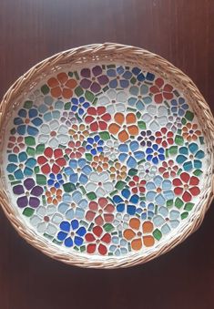 a basket that has been decorated with multicolored glass pebbles in the shape of hearts