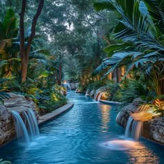 an outdoor swimming pool surrounded by trees and water features waterfall cascading over the edge