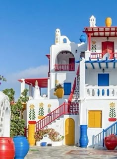 a large white building with red, yellow and blue decorations on it's sides