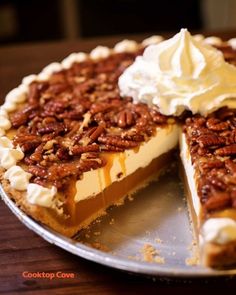 a pie with pecans and whipped cream on top