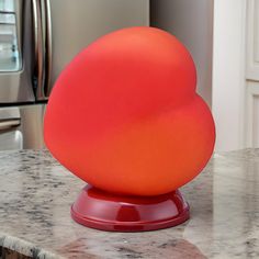 an orange ball sitting on top of a kitchen counter