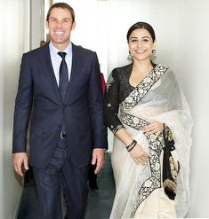 a man and woman walking down a hallway