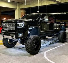 a large black truck parked in a garage