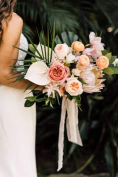 a woman holding a bouquet of flowers in her hands