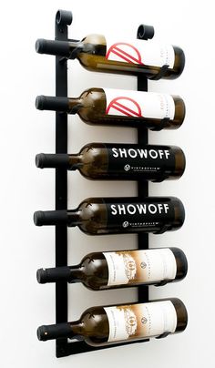 a wine rack that has several bottles on it and is attached to the wall with two hooks