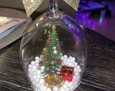 a snow globe with a christmas tree in it