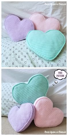 three different heart shaped pillows sitting on top of a bed