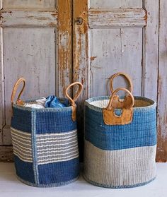 two blue and white baskets sitting next to each other