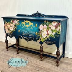 an ornate painted blue cabinet with flowers on it