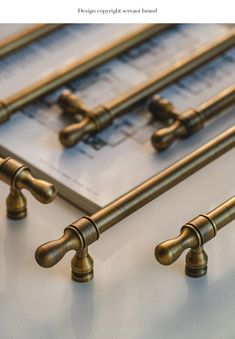 four brass handles on top of a sheet of paper