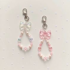 two pairs of pink and white beaded earrings with bowknots on them