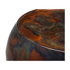 a brown and black vase sitting on top of a table