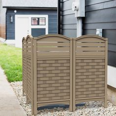 a brown fence sitting next to a black house