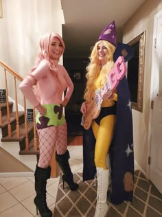 two women dressed in costumes standing next to each other