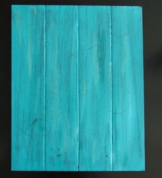 a blue wooden block sitting on top of a table