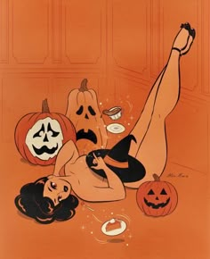 a woman laying on the floor surrounded by pumpkins