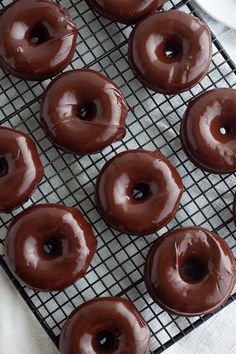 chocolate covered donuts cooling on a wire rack