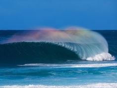 two rainbow colored waves in the ocean