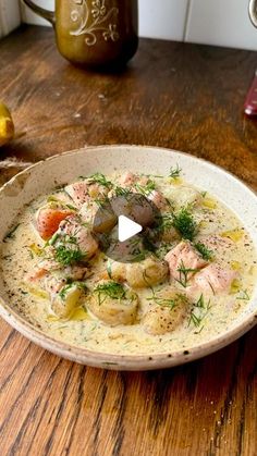 a bowl filled with soup sitting on top of a wooden table