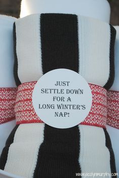 a close up of a white and black striped cup with a red ribbon around it