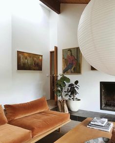 a living room filled with furniture and a fire place in front of a painting on the wall