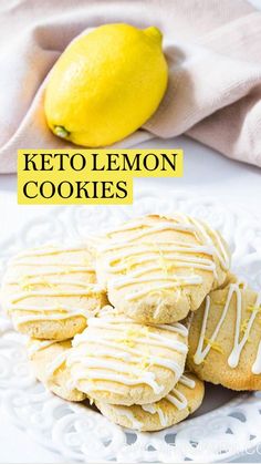 lemon cookies with white icing on a plate next to a lemon and a napkin