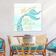 a living room with wicker chairs and a painting on the wall that says mermaid kisses & kisses'n wishes