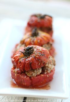 tomatoes stuffed with meat and sauce on a white plate