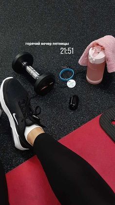 the woman is doing exercises with her feet on the mat and holding a water bottle