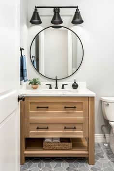 an image of a bathroom vanity with lights above it and the caption that reads, how to decorate a small bathroom on a budget