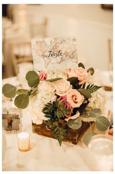 a table with flowers and candles on it