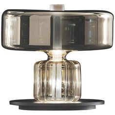 a glass table lamp with a black base