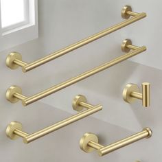 four brass bathroom accessories hanging on the wall