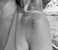 a woman with a small tattoo on her shoulder