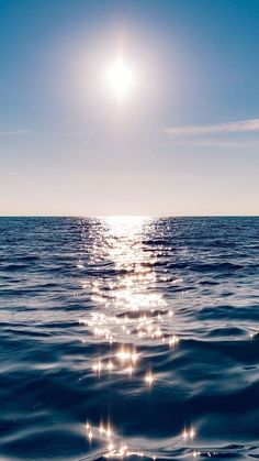 the sun shines brightly over the ocean as it reflects off the water's surface