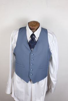 "ALL CLOTHING SALES ARE FINAL. How sharp is this vest, though? Wow. And guess what? It's reversible! Two vests in one. The one side is blue with two pockets, and the reverse is blue plaid. No smoke, damage or mildew. No tags. 36R chest. Measurements:  Chest: 36\" Length: 24\" Pair with many of the handsome ties available in the shop right now and save on shipping! I'm here to make you look good. What a fun item! Thank you for looking!" Classic Blue Cotton Vest, Retro Fitted Sleeveless Outerwear, Vintage Blue Sleeveless Outerwear, Fitted Blue Vest Outerwear, Vintage Fitted Sleeveless Outerwear, Fitted Sleeveless Vintage Outerwear, Fitted Vintage Blue Vest, Blue Fitted Vintage Vest, Classic Blue Sleeveless Outerwear