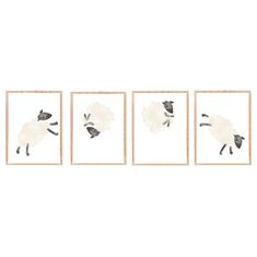 three sheep are hanging on the wall in front of two framed pictures, one is black and white