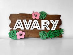 a wooden sign that says avary with flowers on it