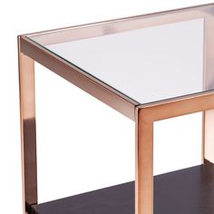 a glass and metal end table sitting on top of a wooden shelf with shelves underneath it