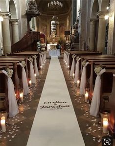 the aisle is decorated with candles and flowers