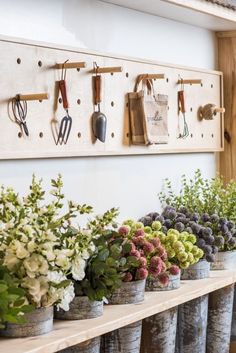 an instagram photo with flowers and utensils hanging on the wall above them