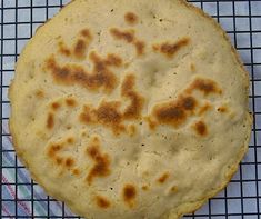 an uncooked flat bread on a cooling rack