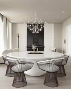 a dining room table with chairs and a chandelier