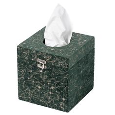 a tissue box that is green with gold speckles on it and a white tissue in the middle