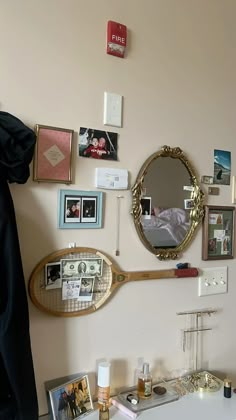 there is a mirror and some pictures on the wall