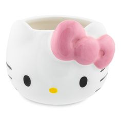 a hello kitty cup with a pink bow on it's head and black eyes