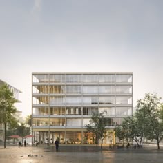 an office building with many windows and people walking around the outside area in front of it