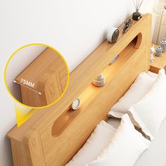 a bed with white pillows and a wooden headboard that has an arrow pointing to it